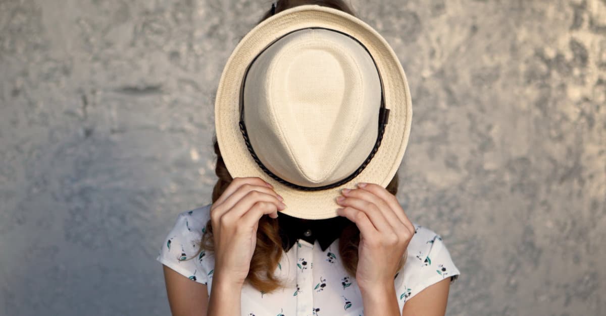 Young girl with hat. Hides her face.Depression.