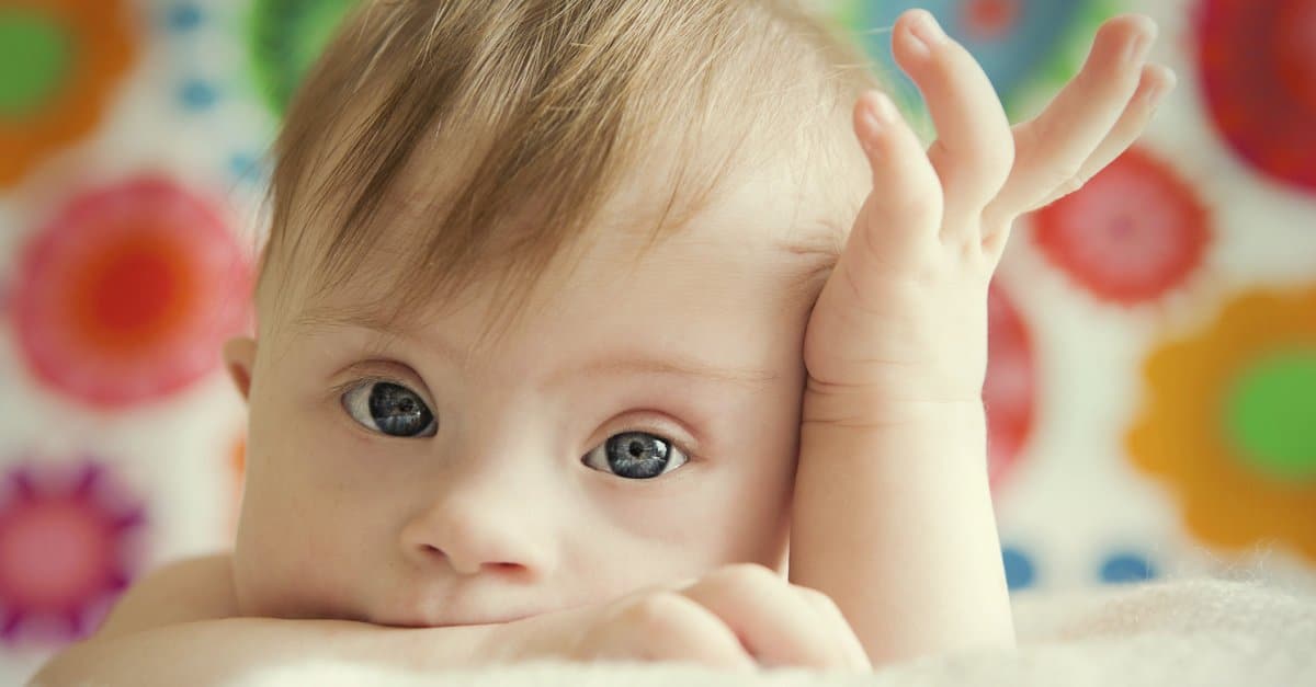 A cute baby girl posing for picture