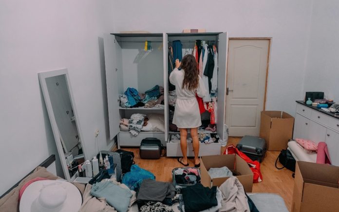 Nice-looking lady inside modern apartment room prepare to trip, around the mess Desorganizado? veja o que isso revela sobre sua mente, segundo a psicologia